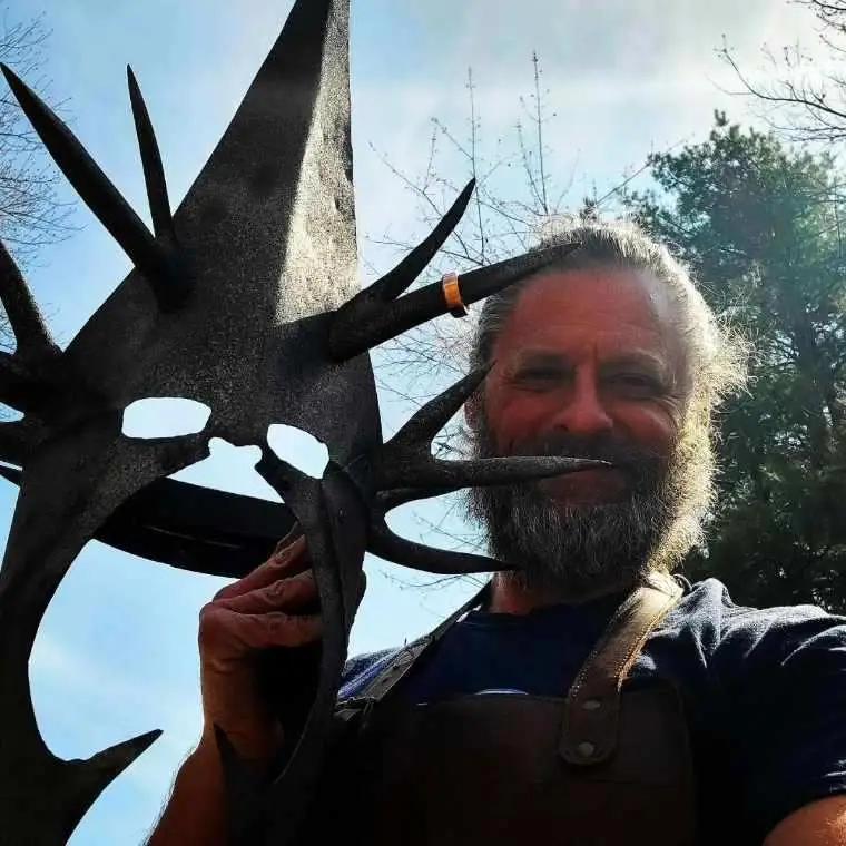 The artist with a finished sculpture